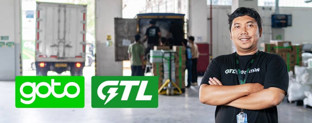 A person wearing black shirt with a truck trying to unload in the background