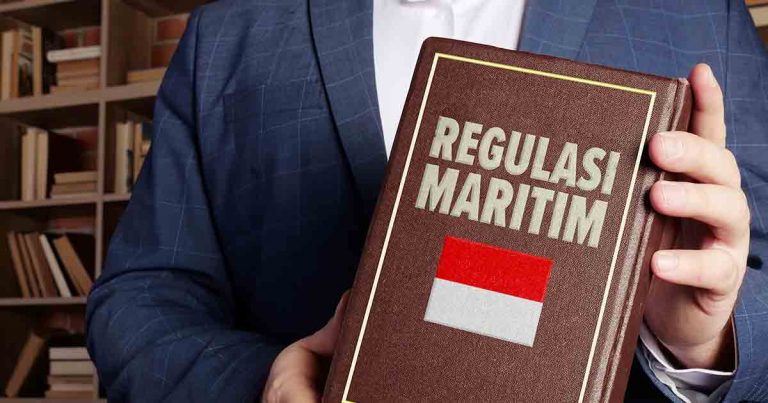 Buku coklat bertuliskan regulasi maritim dengan bendera indonesia