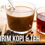 Dua gelas berisi kopi dan teh dengan biji kopi dan daun teh di atas meja.